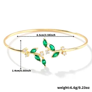 Close-up of golden willow leaf bangle with green marquise zircon and dimensions detail