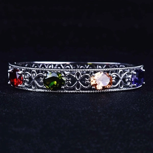 Vintage silver hollow-out cuff bracelet featuring colorful oval-cut tourmaline gemstones
