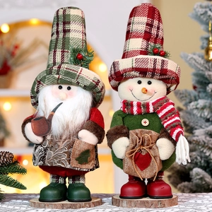 Detail of Christmas gnome and snowman plush figurines with plaid hats on wood base