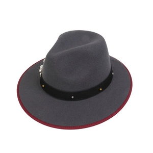 Detail of dark grey fedora hat with burgundy trim, pearls and metallic bullhead studs