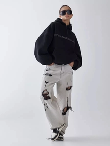 Streetwear oversized black hoodie and distressed jeans styled for a casual aesthetic