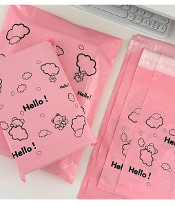 Detailed view of pink waterproof mailers with cartoon bear pattern and Hello text
