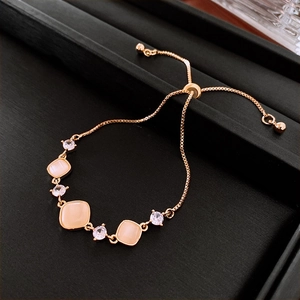 Detail of rose gold sliding bracelet with square cat-eye stones and zircon accents