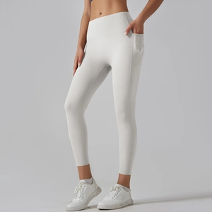 Close-up of high-waisted seamless yoga leggings in beige with functional side pocket