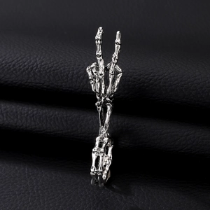 Silver skull hand shaped open ring in gothic vintage style on black background