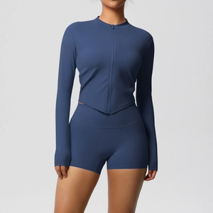 Detail of navy yoga set featuring asymmetric V-hem zip top and thumbhole cuffs