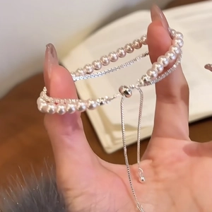 Detail of double-layer pearl and zircon bracelet with adjustable sliding clasp closure