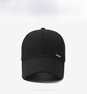 Close-up of black baseball cap with gold KOMONT embroidery and six-panel cotton texture