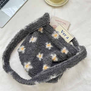 Detail of gray fleece bucket bag with daisy floral prints and soft plush texture