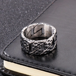 Close-up of retro titanium steel tire tread ring with hammered finish on black leather