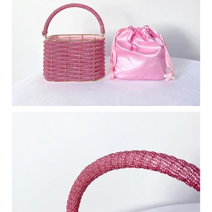Detail of pink beaded bucket bag with drawstring satin lining and handle close-up