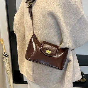 Elegant dark coffee patent leather shoulder bag with gold clasp and adjustable strap