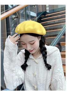 Close-up showing the soft wool texture of the vibrant yellow beret for women