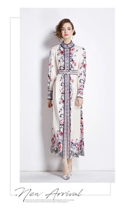 Detailed close-up of floral print dress featuring a stand collar and matching waist belt