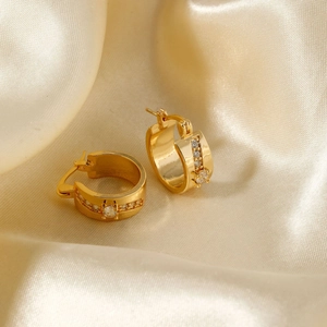Detail of 18K gold plated hoop earrings with central round zircon and pavé setting