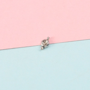 Close-up of hexagonal stainless steel connector with two side loops for DIY jewelry making
