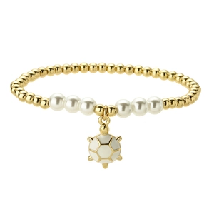 Golden beaded bracelet with white pearls and a soccer ball charm on white background