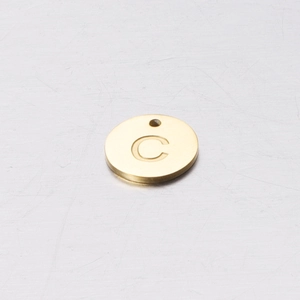 Detailed close-up of a 12mm golden stainless steel round pendant with engraved letter C