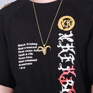 Close-up of a men's golden ram skull pendant with horns on a stylish hip hop necklace