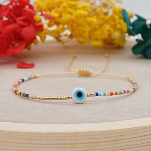 Bracciale bohémien occhio malevolo con perline colorate e cordino d'oro regolabile