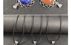 Detailed close-up of hexagram pendants with blue crystal and tiger eye stone in silver base