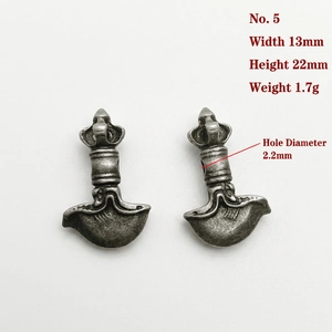 Detail view of antique silver Vajra pendant with measurements 13x22mm and 1.7g weight