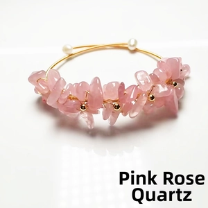 Macro detail of handmade rose quartz crystal bracelet with 14K gold wire and pearls