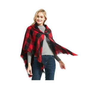 Detail of red and black plaid poncho with leather buckle and fringe trim edge