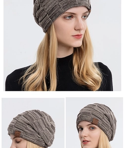 Detail of taupe marl knit beanie with waffle texture and sport leather patch