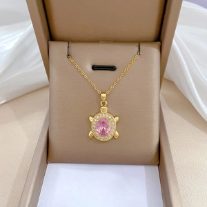 Elegant gold turtle necklace with pink oval gemstone and sparkling white crystals