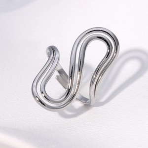 Macro view of polished stainless steel ring with minimalist wavy S-shape double layers