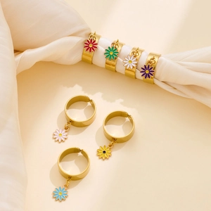Adjustable gold stainless steel rings with colorful enamel daisy charms on white silk