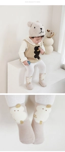 Close-up of non-slip baby socks with cute sheep pattern and soft fleece lining