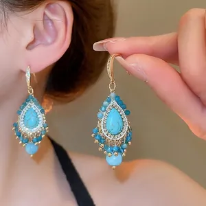 Bohemian turquoise and pearl drop earrings with crystal fringe and gold accents