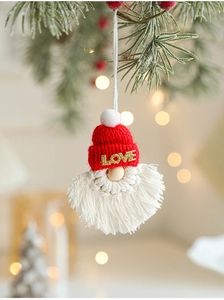 Detail of handmade knit Christmas gnome ornament with LOVE text and cotton fringe