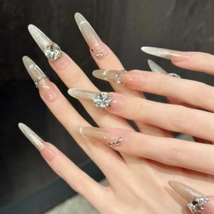 Extra long stiletto press-on nails with silver cat-eye gradient and sparkling rhinestones