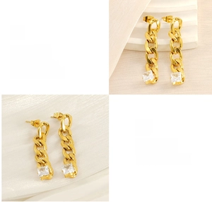 Detail of gold Cuban chain earrings featuring polished finish and square zircon stone