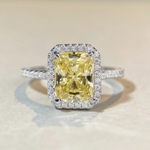 Macro detail of radiant cut yellow gemstone ring with halo diamonds and pavé band