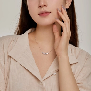 Close-up of minimalist S925 silver necklace with V-shaped sparkling cubic zirconia pendant