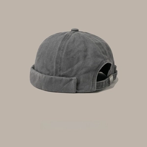 Detail view of washed grey cotton brimless cap with vintage texture and metal buckle