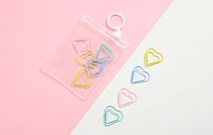Colorful heart-shaped paper clips in macaron colors with a clear plastic pouch