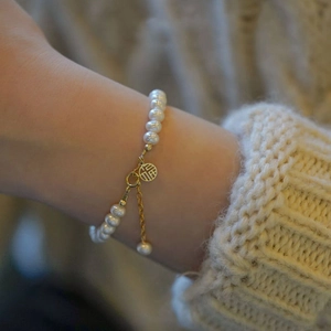 Emerald freshwater pearl bracelet with gold Fu pendant and irregular titanium steel design