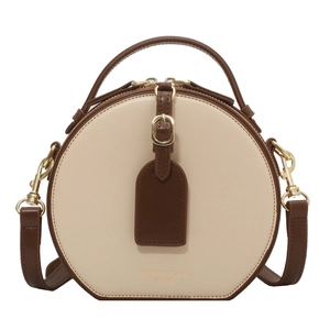 Fashion round crossbody bag in beige and caramel leather with gold hardware and top handle