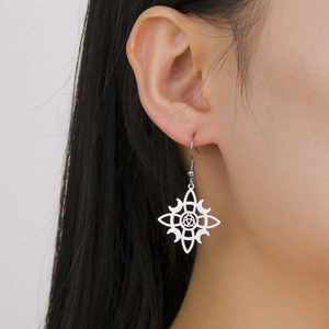 Women silver witch knot moon pendant earrings in stainless steel on ear model