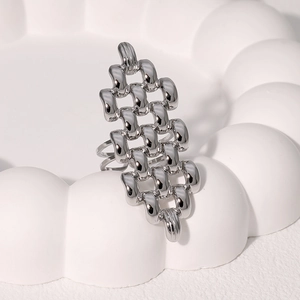 Detail shot of the woven chain texture on a silver stainless steel geometric open ring