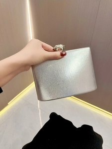 Silver glitter evening clutch bag with a large crystal clasp for party dress occasions