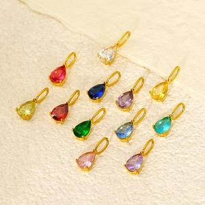 Twelve colorful pear-cut birthstone pendants with gold plated titanium steel bases