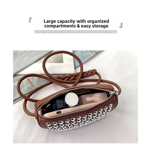 Brown leather cylinder bag interior showing high capacity storage for cosmetics