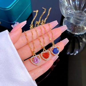 Three dainty heart-shaped gold necklaces with pink, red and blue micro-paved crystal pendants