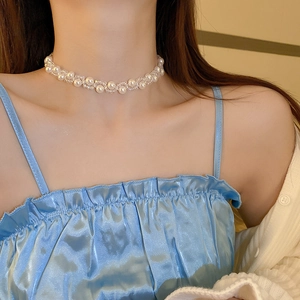 Close-up of French vintage faux pearl and crystal choker necklace on model neck